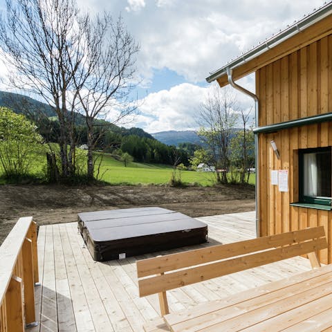 Slip into the sunken hot tub and admire the mountain view from the terrace