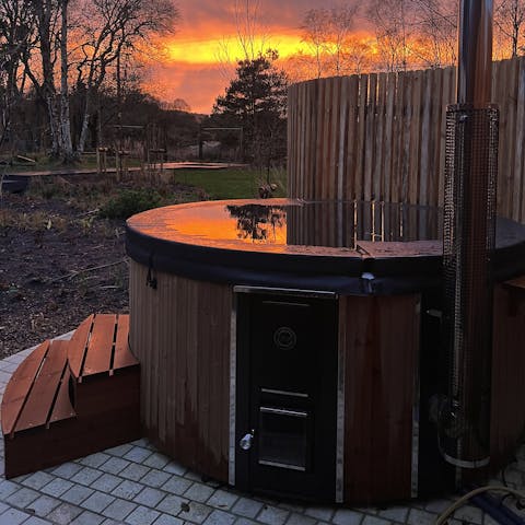 Admire sunsets from the hot tub in the beautiful garden