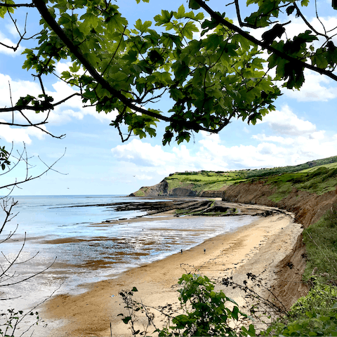 Stroll along the sands of Whitby Beach, it's a ten-minute drive away