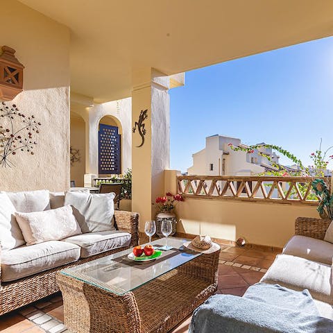 Pour a glass of wine and relax in the shade of the private terrace