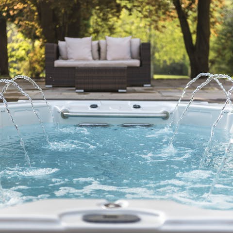 Unwind in the hot tub while admiring the gorgeous garden