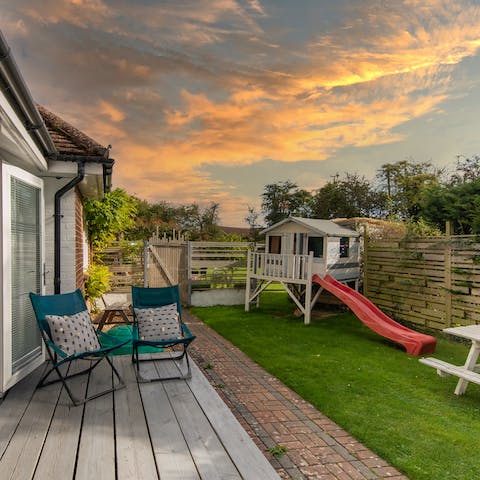 Unwind in the garden with a cocktail while kids play on the slide