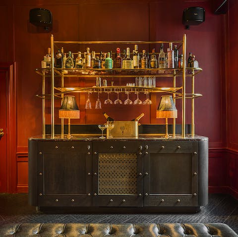 Pour yourself a drink (or have a private butler do it) at the suite's sumptuous bar area
