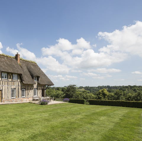 Enjoy the countryside views and extensive grassy lawns of the home's garden