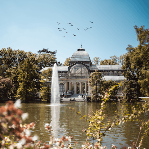 Stroll through El Retiro Park, a green oasis in the heart of the city