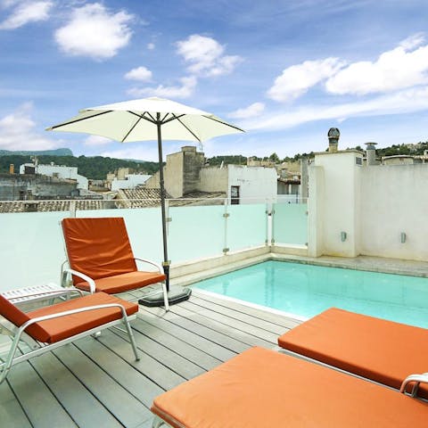 Take in the views of Pollença's rooftops and Tramuntana Mountains from your private roof terrace 