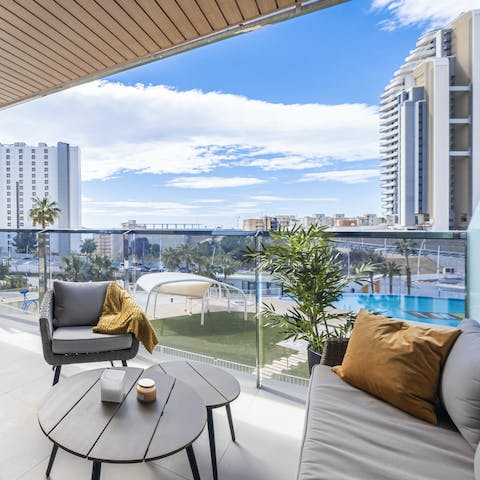 Sip your morning cup of coffee as you look out over the pool and the sea beyond