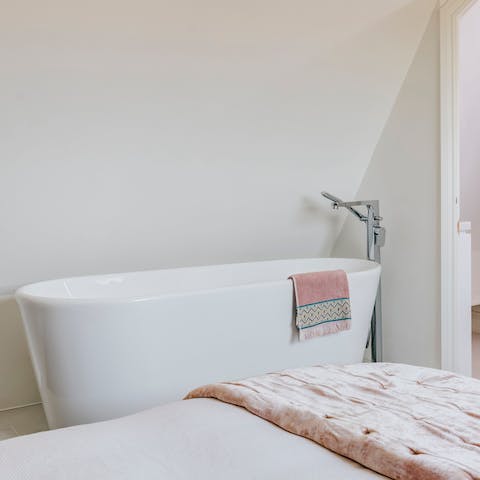 Treat yourself to a soak in the freestanding bathtub in the bedroom