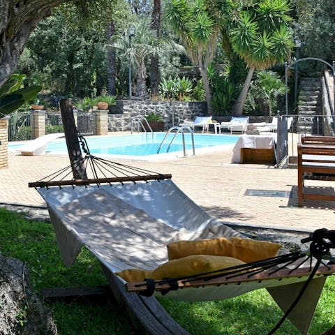Lounge in the garden hammock in the shade of the olive tree