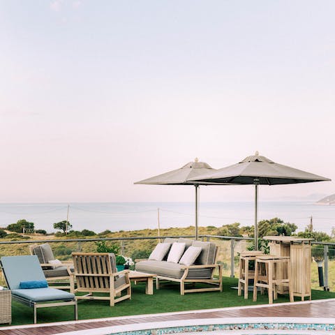 Admire views over the Aegean Sea from the comfy outdoor lounge