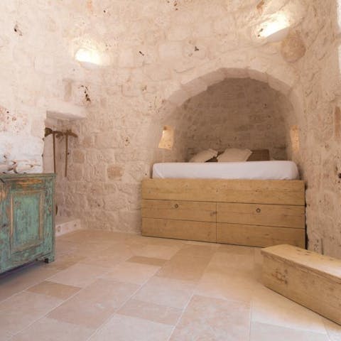 Climb up into your cosy raised bed in the alcove within your home's traditional trullo