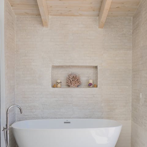 Enjoy a long and lovely soak in the freestanding bathtub, located in the main bedroom