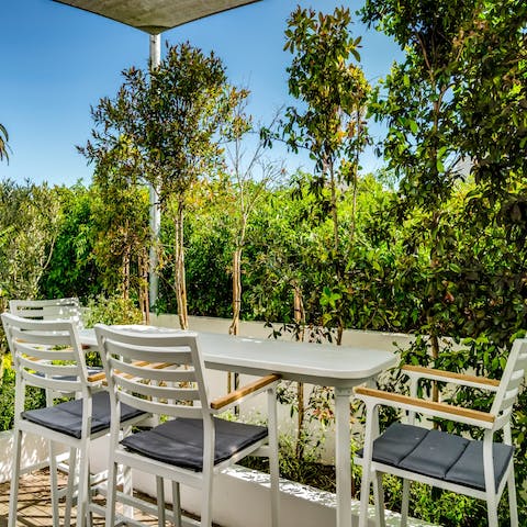Dine alfresco on the beautiful balcony surrounded by lush greenery