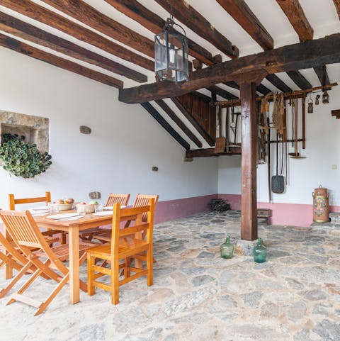Enjoy dining alfresco beneath the wood beams on your private patio