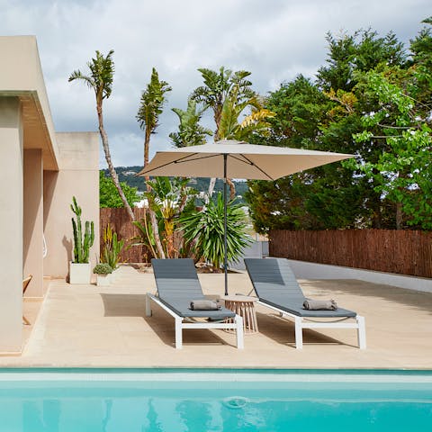 Soak up the glorious sunshine from a poolside lounger