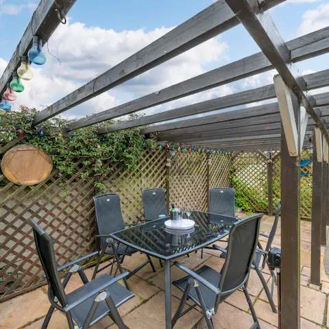 Indulge in a delicious al fresco feast with family and friends beneath the pergola