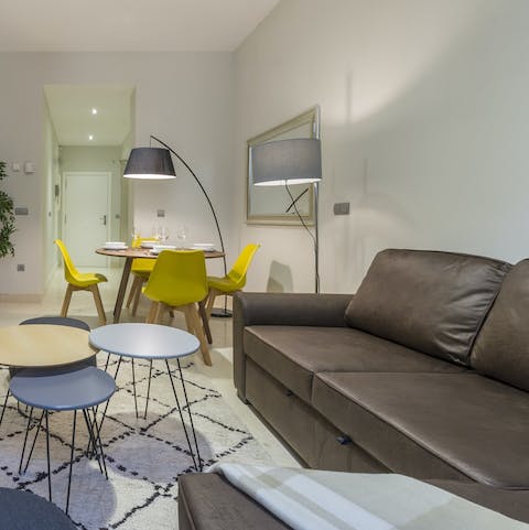 Relax with a glass of red wine on the sofa after a busy day in Madrid