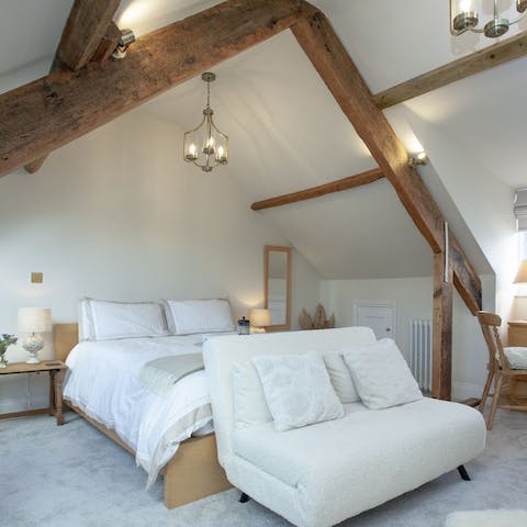 Admire the striking, original wooden beams in the master bedroom