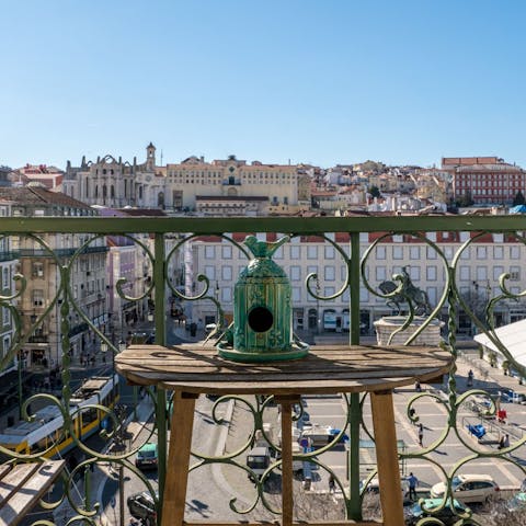 Admire views of Praça da Figueira from the living room's Juliet balcony