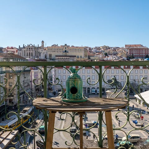 Admire views of Praça da Figueira from the living room's Juliet balcony