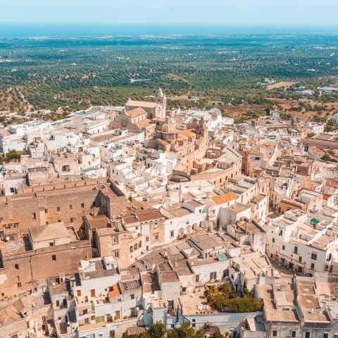 Wind your way through the narrow streets of the historic city of Ostuni