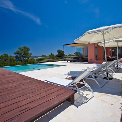 Soak up the warm Ibizan sunshine by the poolside
