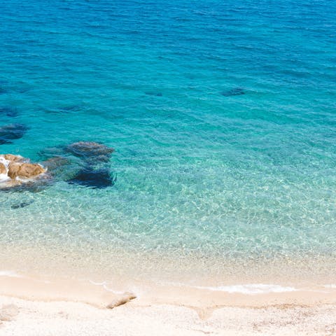 Discover the crystal clear water and white sandy beaches of Mykonos – a fourteen–minute drive away