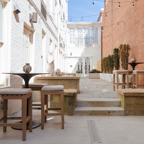 Share a bottle of wine in the communal courtyard, soaking up the last of the evening sun