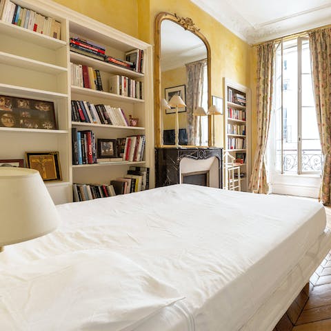 Peruse the main bedroom's bookshelves before enjoying a restful night's sleep