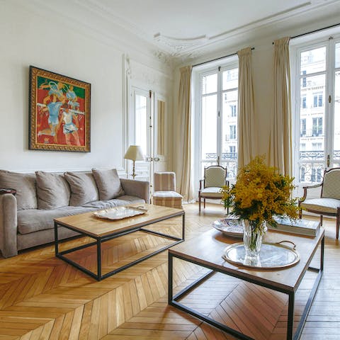 Relax in the grand living room while enjoying the light coming through the French windows