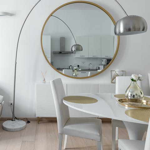 Appreciate elegant design details, such as the arc lamp and gold circle mirror