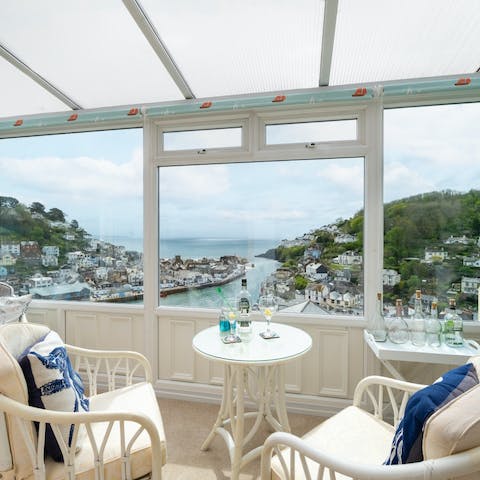 Savour a glass of wine with your view from the sunroom, whatever the weather