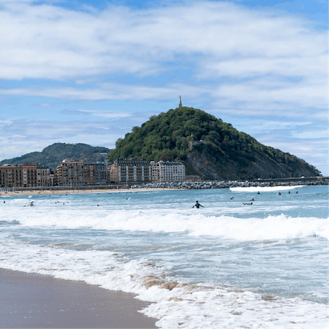 Surf the waves of Zurriola beach, a nine-minute walk from your apartment