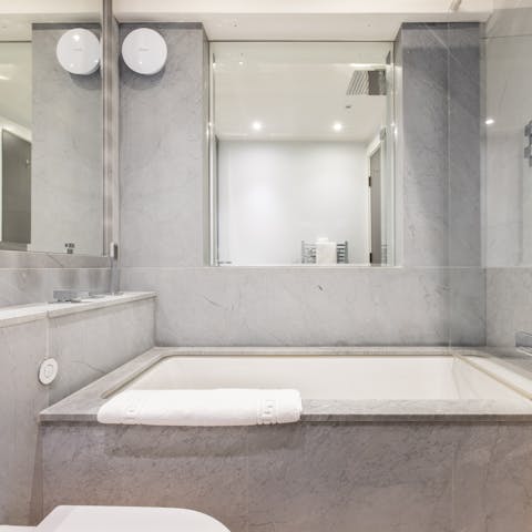 Treat yourself to an indulgent bubble bath in the marble drop-in tub
