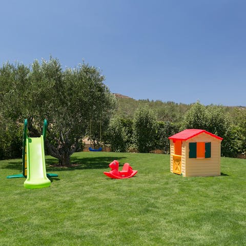 Let little ones slide and swing through a fragrant garden, filled with fruit trees