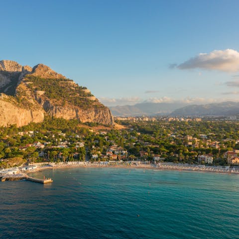 Lay out on the golden sands of Mondello Beach, a five-minute drive north