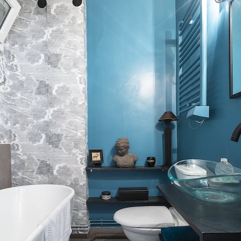 Take a long soak in the stylish blue bathroom