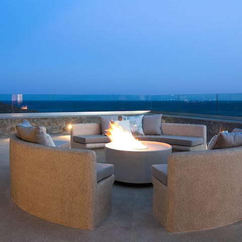 Make the most of the sea breeze long into the night, gathered around the fire pit