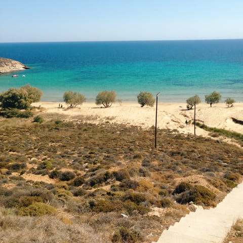 Spend an afternoon lounging on the golden sands of Megali Ammos Beach, a ten-minute drive away