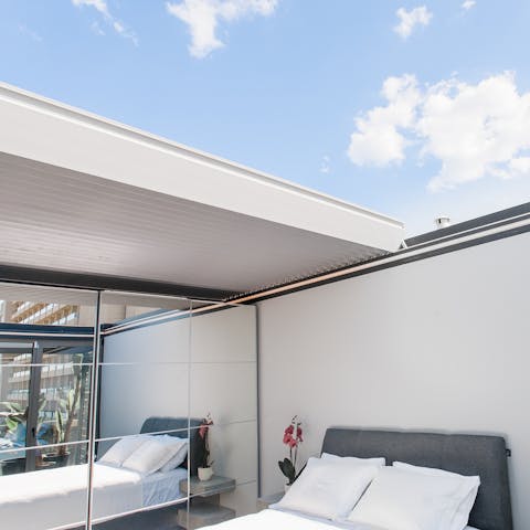 Sleep under the stars by opening up the bedroom celiling
