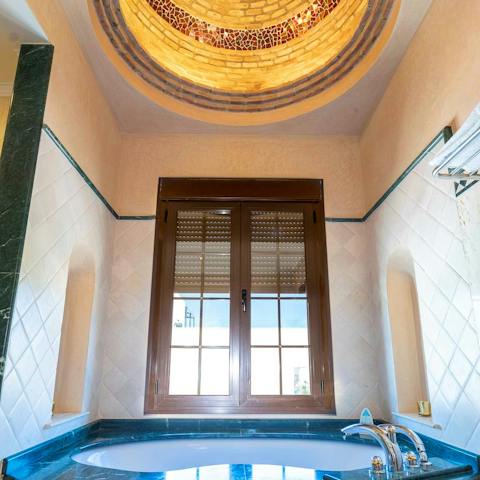 Enjoy a long soak in the impressive tub, set below a magical domed ceiling