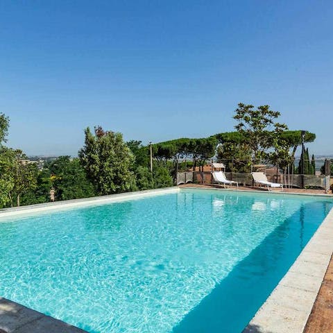 Take a dip in the glistening pool with stunning countryside views around you 