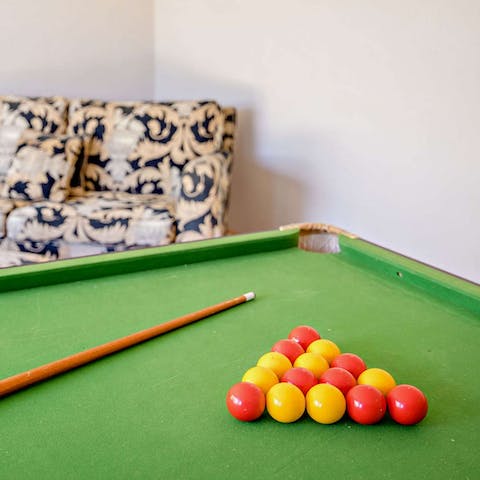 Challenge your family to a game of pool in the summer house