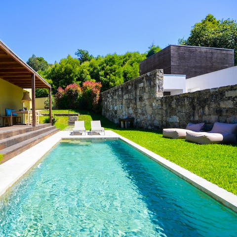 Cool off with a reviving dip in the outdoor pool surrounded by lush greenery