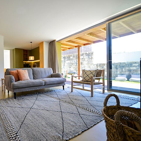 Kick back and relax in the light-filled living room courtesy of floor-to-ceiling sliding glass doors