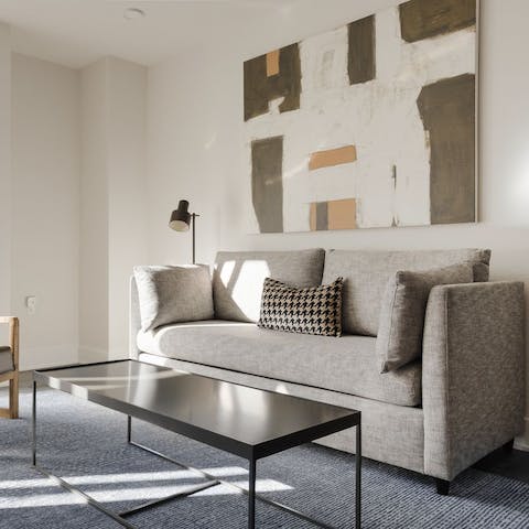 Kick back in the bright living room with a glass of wine after a day of exploring the city on foot