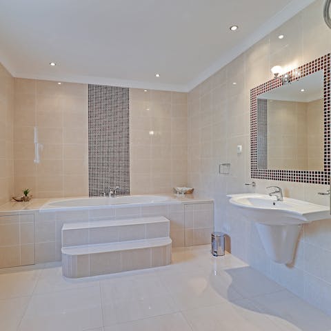 Relax after a busy day with a soak in your elegant bathtub