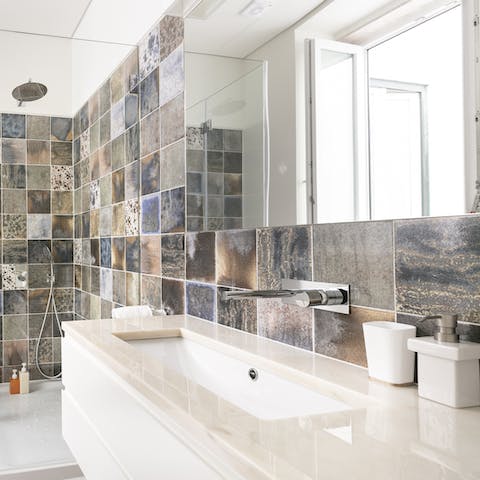 Get ready for a night out in the beautifully tiled bathroom