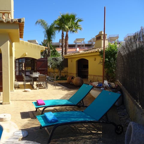 Soak up the sunshine from the sun loungers by the pool