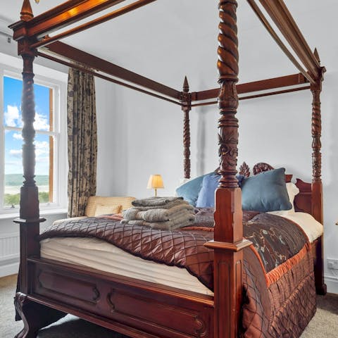 Relax in the four-poster bed after a walk around the estate's 4 acres of woodland